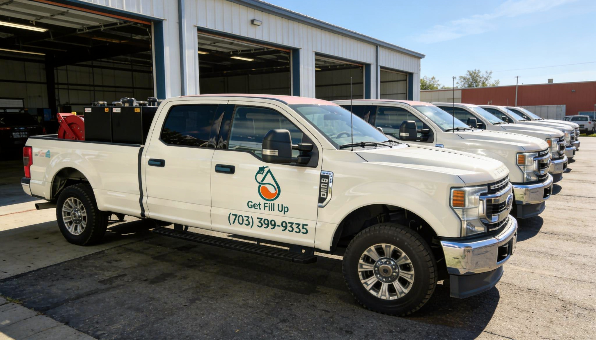 Get Fill Up driver smiling beside the fuel delivery truck at night